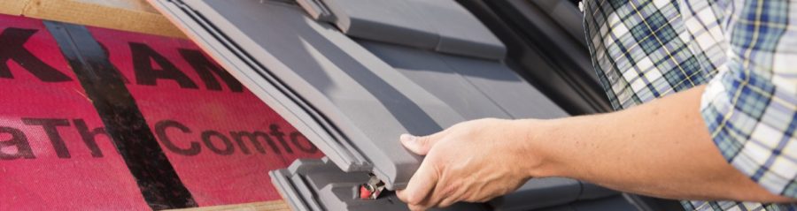 Roofer installing Actua roof tiles