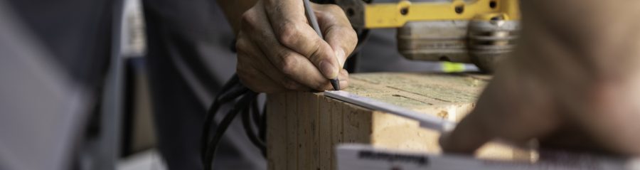Field service employee at construction site supporting building professional in front of van
